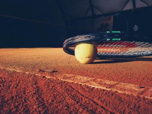 Tennis ball and racket on a tennis court